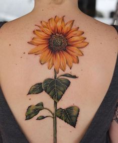 a woman with a sunflower tattoo on her back