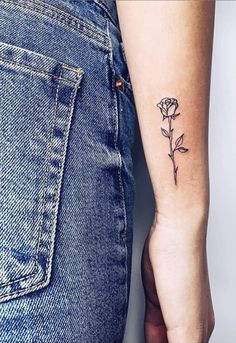 a small rose tattoo on the left arm