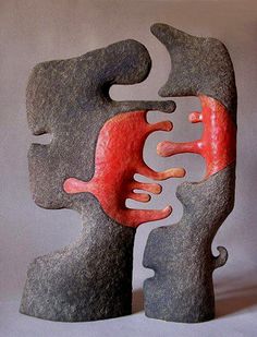 an abstract sculpture with red and black shapes