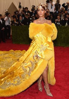 a woman in a yellow gown and fur coat