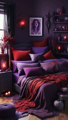 a bedroom decorated in purple and red with candles on the bed, pillows and blankets