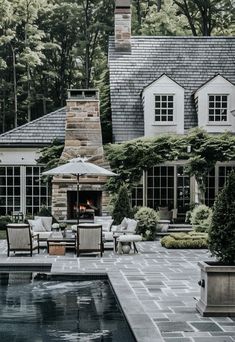 a house with a pool and patio furniture