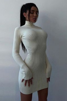 Enhance your wardrobe with this timeless Ashley long sleeve high neck knitted mini dress. Featuring a flattering high neck and long sleeve design, this timeless dress is crafted from a tight knitted fabric that ensures a snug fit. Perfect for the winter season, it offers an elegant and timeless silhouette that never goes out of style. White Long Sleeve Ribbed Bodycon Dress, White Bodycon Sweater Dress For Winter, White Fitted High Neck Sweater Dress, Fitted White High Neck Sweater Dress, Fitted High Neck White Sweater Dress, Chic Long Sleeve High Stretch Dresses, White Ribbed Bodycon Dress For Fall, Long Bodycon Dress For Winter, Spring Bodycon Turtleneck Sweater Dress