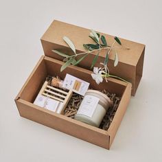 an open box containing candles, soaps and other items