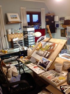 an artist's studio with easel, canvass and other art supplies