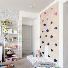 a bedroom with white walls and blue flowers on the wall