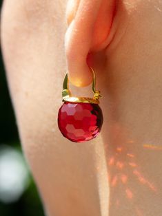 These graceful ruby crystal earrings are a versatile option that will suit your delicate jewelry taste. The glitzy sphere crystals are available in a wide range of colors so that you can find the perfect pick for your outfits. The faceted surface refracts the light like a disco ball, resulting in a glorious sparkle that turns heads. Also, their transparency interacts playfully with different shades of light, resulting in different hues of their color. These flashy red crystal ball earrings come Ruby Red Jewelry, Crystal Ball Earrings, Garnet Drop Earrings, Colored Earrings, Ruby Crystal, July Birthstone Jewelry, Ball Earrings, Aquamarine Crystal, Ruby Earrings