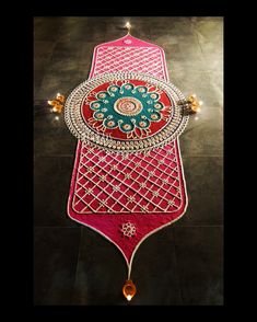 an intricately decorated table with beads and jewels on the top is shown from above