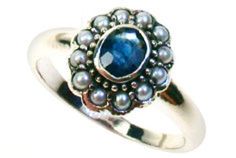 a ring with pearls and a blue stone