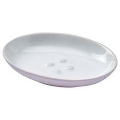 a white bowl with three holes in the center and two small buttons on the side