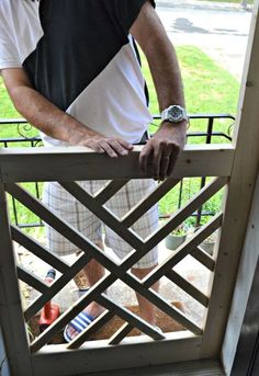 a man standing on a porch with his hand on the railing