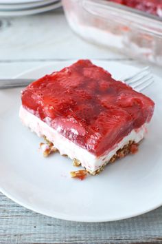 a piece of cake sitting on top of a white plate next to a knife and fork