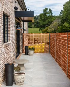 a brick building with two planters on the front and one in the back ground