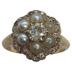 an antique diamond and pearl cluster ring