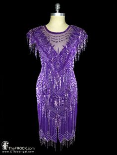 "BIG NEWS After 22 years, our website, TheFROCK.com, has had a makeover. Check out the new site, and join our mailing list for new arrivals.  Vintage Saks 5th Avenue heavily beaded dress with beaded fringe. Lined. Rear zipper. Measures bust 36.5\", waist 32\", length 43.5\" to bottom of fringe. Condition is excellent.  Layaway is available. ALL DELIVERY DATES mentioned by Etsy are ESTIMATES, no delivery date or range is guaranteed, though most of our orders arrive ahead of estimate. And of cours Fitted Purple Evening Dress For Party Season, Fitted Evening Dress With Beaded Fringe For Night Out, Fitted Beaded Fringe Evening Dress For Night Out, Fitted Beaded Fringe Evening Dress For Gala, Fitted Evening Dress With Rhinestone Fringe For Party Season, Fitted Beaded Fringe Flapper Dress For Gala, Purple Flapper Dress, Beaded Fringe Dress, Gown Chiffon