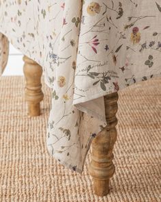 an upholstered bed with floral print on it