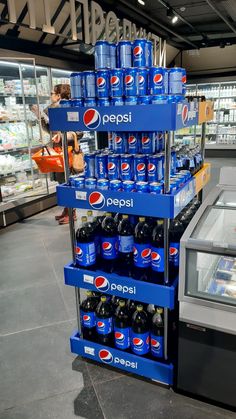 pepsi soda stacked on top of each other in a store