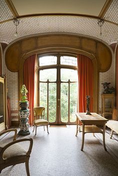 a living room filled with furniture and a large window