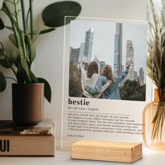 a couple of people standing next to each other on a table with plants in the background