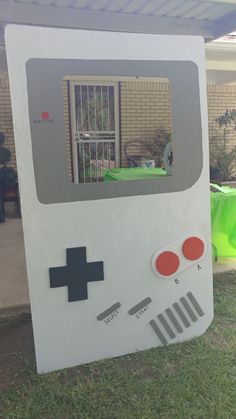 an old fashioned video game costume sitting on the grass in front of a brick building