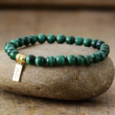 The Handmade Natural Malachite Beaded Bracelet with a Gold Plated Tag looks great. It will make the perfect gift 🎁 for someone special, or treat yourself as you deserve it 💖 🥰 These Bracelets have been made using high quality Natural Malachite and have a Gold Plated Tag with MC for MantraChakra. They are available as 4mm, 6mm and 8mm. Malachite is used as a protective gem due to its immense powers of protection. It is the stone of unconditional Love and Relationships and is a universal healin Bracelet Pierre Malachite, Luxury Green Malachite Bracelet, Luxury Malachite Jewelry With Polished Beads, Luxury Malachite Gemstone Beads Jewelry, Malachite Bracelet Ideas, Luxury Malachite Jewelry With Round Beads, Handmade Malachite Beaded Bracelets For Spiritual Use, Green Malachite Beaded Bracelets As Gift, Handmade Malachite Spiritual Beaded Bracelets