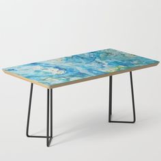 the table is made out of wood and has an abstract design on it, with black metal legs