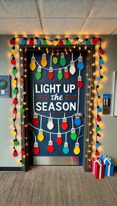 an office door decorated with christmas lights and presents