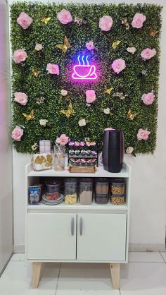 a coffee bar with pink flowers on the wall