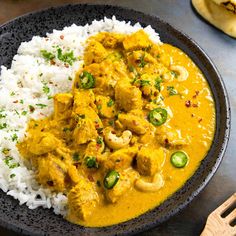 a plate filled with rice and chicken curry