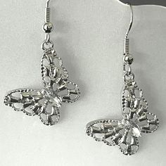 New Vintage Style Delicate Silver-Plated Filigree Butterflies With Clear Marquise-Cut Rhinestones For The Body. These Earrings Are Lightweight Dangles, And Measure 1-1/2" Long And 7/8" Wide. They Have Silver-Plated Fishhook Ear Wires. These Fun And Whimsical Earrings Would Make A Great Birthday Gift. * There May Be Some Color Discrepancies Due To Different Monitor Settings. The Colors Are Described As Clearly And Genuinely As Possible. * All Items Are Created In A Smoke-Free And Pet-Free Studio. Nickel-free Butterfly Shaped Silver Earrings, Nickel-free Silver Butterfly Earrings, Silver Filigree Earrings For Party, Silver Butterfly Earrings For Wedding, Whimsical Earrings, Silver Butterfly Earrings, Butterfly Rhinestone, Gold Heart Earring, Stone Dangle Earrings