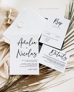 the wedding stationery is laid out on top of each other, with an envelope