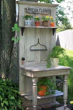 a potted plant sitting on top of a wooden shelf next to a white cabinet