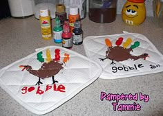 two pot holders with turkeys on them