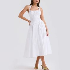 Embrace timeless beauty with this stunning A-line fit and flare midi dress. The halter neck provides a classic yet contemporary look, ideal for any fashionable wardrobe. Delicately crafted with pleated sides on the skirt, this dress combines elegance with a playful twist. Whether you’re attending a garden party, a cocktail event, or a dinner date, this dress is your go-to for effortless style and grace. Color: White, Pink, FloralSilhouette: Fit & FlareLength: MidiMaterial: PolyesterNeckline: Hal Chic A-line Tea Length Dress For Garden Party, Ruched A-line Midi Dress For Cocktail, Chic A-line Midi Dress For Garden Party, Chic A-line Tea Length Summer Dress, Chic A-line Tea Length Dress With Pleated Bodice, Spring A-line Midi Dress With Lined Bodice, Feminine A-line Midi Dress With Ruched Bodice, Chic Fitted Bodice Pleated Dress, Chic A-line Midi Dress With Pleated Skirt