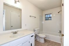 a bathroom with a sink, toilet and bathtub