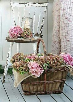 two baskets filled with flowers sitting on top of a wooden floor next to a white chair