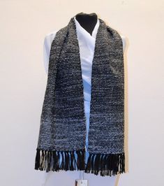 Unique handwoven item Unique handwoven item in 100% black wool warp and weft of twisted wool yarn in shades of grey.  Warp in pure wool 100%, pure wool 80% weft and acrylic 20%. From the broad edge in light grey towards the center where alternating black and grey threads give it a special sheen.  Each piece is made with the heart, care and attention to detail, using high quality yarns:  Hand knotted fringe. Unisex. 10,24x54,37 ooooooooooooooooooooooooooooooooooooooooooooooooooooooooooooooooooooo Black Wool Shawl For Winter, Black Wool Winter Shawl, Black Alpaca Shawl For Winter, Black Wool Scarves For Cold Weather, Wool Handwoven Winter Scarves, Winter Wool Handwoven Scarves, Handwoven Wool Scarves For Winter, Black Wool Scarf For Winter, Knotted Fringe