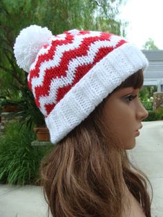 a mannequin head wearing a red and white knitted hat