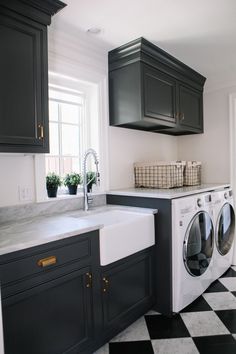 a black and white checkered floor in a laundry room with washer and dryer