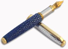 a blue and white pen with gold trim