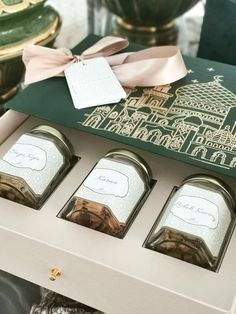 three boxes with teas in them sitting on a table next to some other items