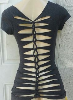 the back of a woman's black top with cutouts and ties on it