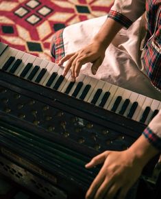 a person is playing an organ on the floor