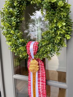 a wreath is hanging on the front door