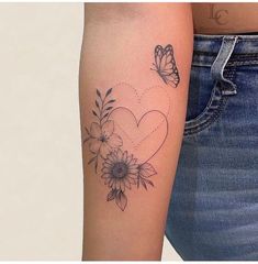 a woman's arm with a butterfly and flower tattoo on the left side of her arm