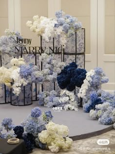 blue and white flowers sitting on top of a table