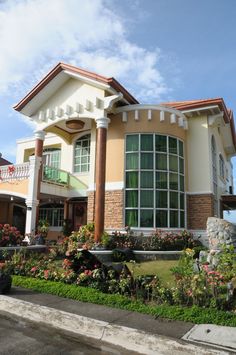 a large house with lots of windows and landscaping