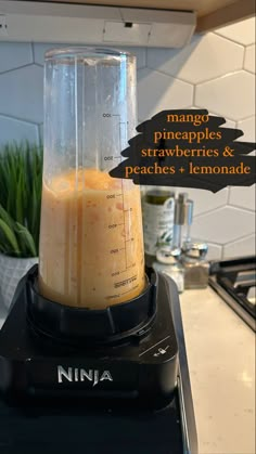 a blender filled with liquid sitting on top of a counter