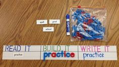 some writing materials are laid out on a wooden table with markers, pens and plastic bags