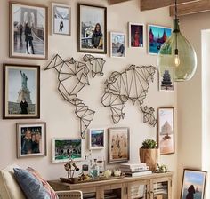 a living room filled with furniture and lots of pictures on the wall next to a window